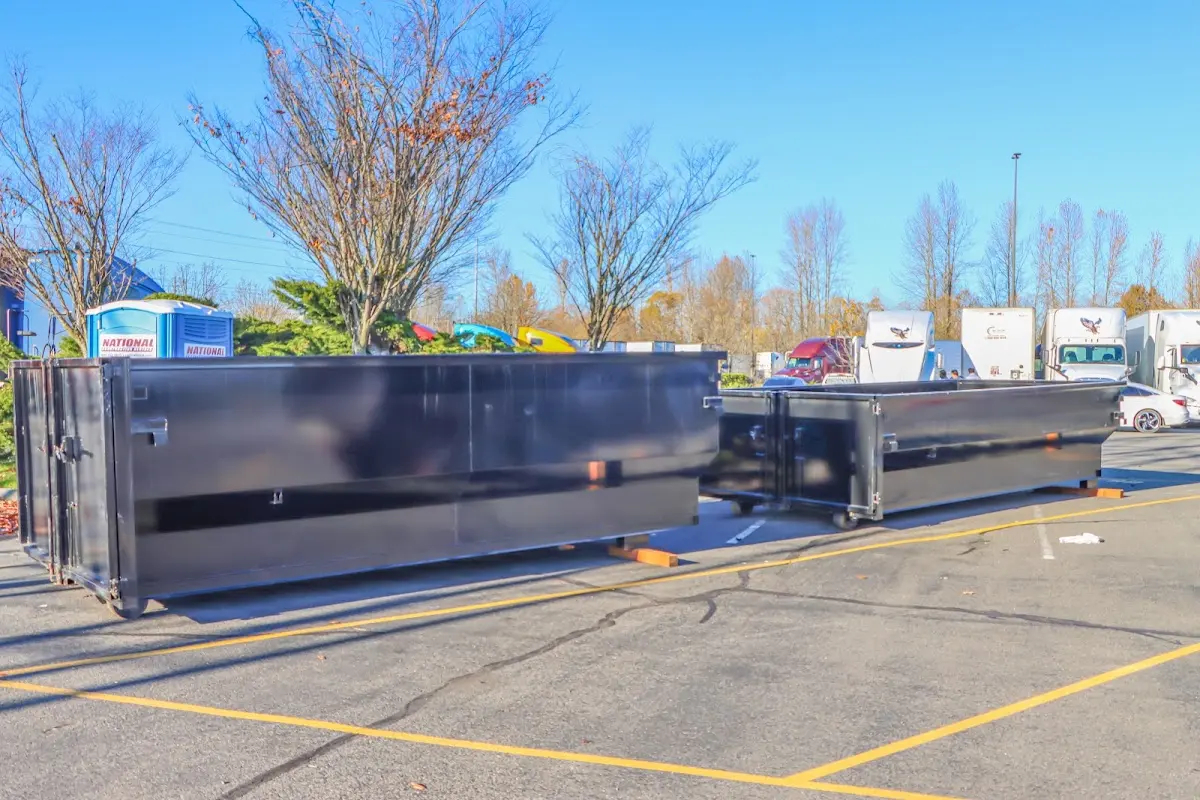 Professional dumpster rental service with roll-off container on residential driveway in Eldorado at Santa Fe